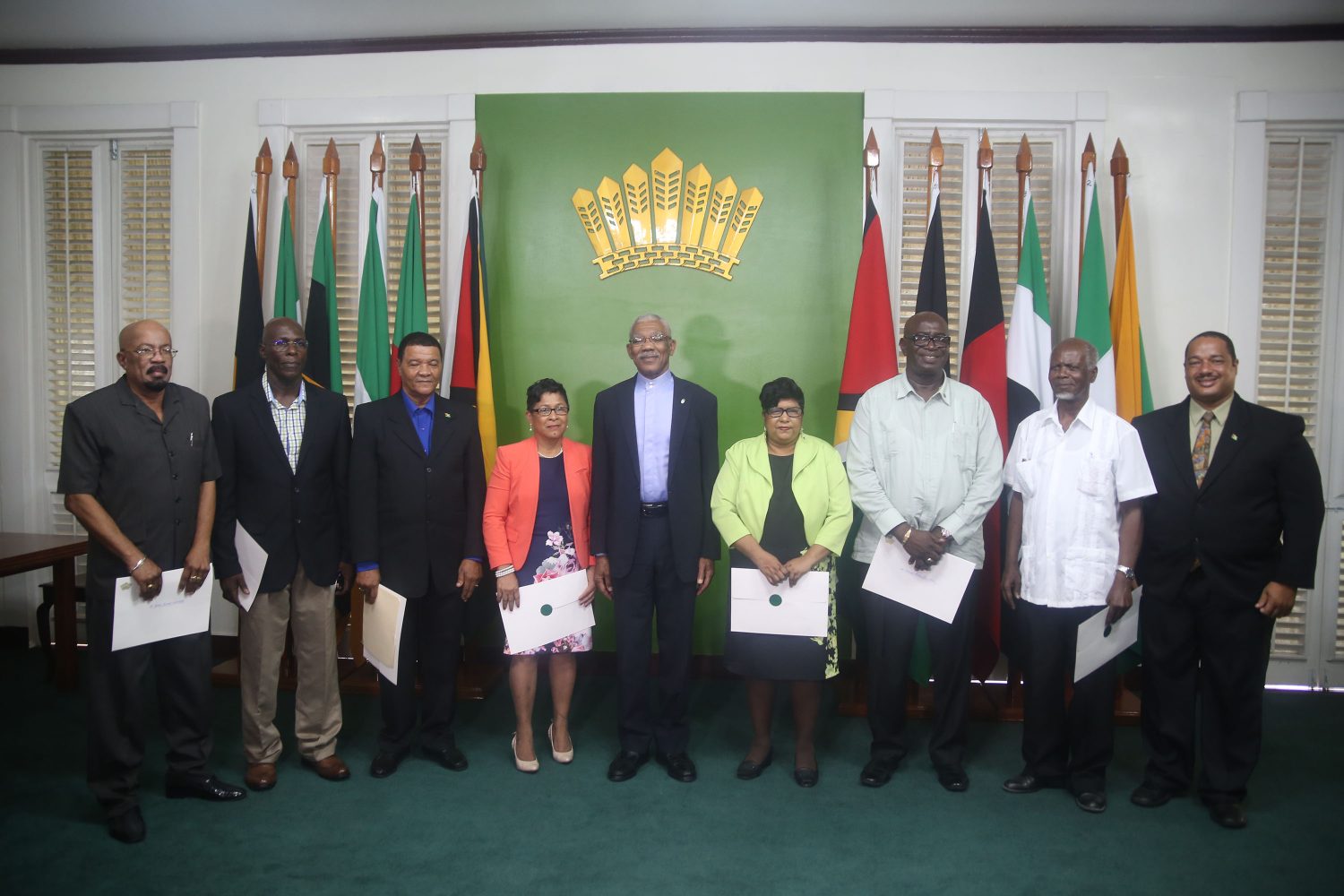 President David Granger (centre) with the members of the newly sworn in Local Government Commission. From left are Norman Whittaker, former Minister of Local Government and Regional Development; trade unionist Andrew Garnett; former Region 4 Chairman Clement Corlette; Joan-Ann Romascindo; former Town Clerk for the City of Georgetown Carol Sooba; former Region 10 Chairman Mortimer Mingo;  former Minister of Local Government and Regional Development Clinton Collymore and Marlon Williams. (Keno George photo)