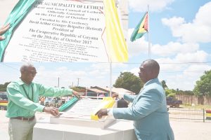 President David Granger (left) and Mayor Carlton Beckles unveil the plaque (inset) to officially declare Lethem a town ​yesterday. (Ministry of the Presidency photo) 