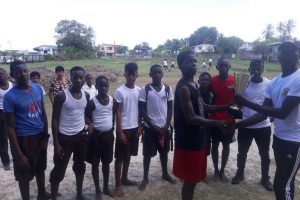 Captain of ‘A’-House Markel Matterson receives the championship trophy from a school teacher in the presence of his team-mates after defeating ‘C’-House in the final.