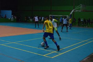A Brazilian player (yellow) tries to get past a North Ruimveldt player during their clash in the Street Vybz Entertainment Futsal Championship at the National Gymnasium Saturday night. Pix saved as Brazilian2