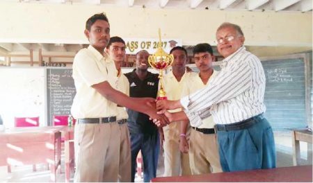 New Amsterdam Multilateral School emerged the winner of the 2017 Berbice Inter-Schools Chess Championship last month as the newly established Berbice Chess Association held its first activity. In photo: Krishnanand Raghunandan (right), President of the Berbice Chess Association presents the winning team with a trophy. The members of the winning team are: Charran Woarti, Demetre Prettipaul, Yutesh Dyal and Devon Kissoon.