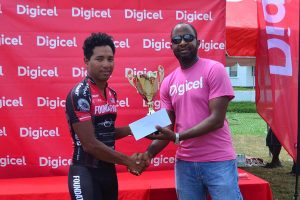  Digicel Guyana CEO, Gregory Dean, presents the proceeds (almost half a million dollars) to a representative of the Cancer Institute of Guyana. (Orlando Charles photo)