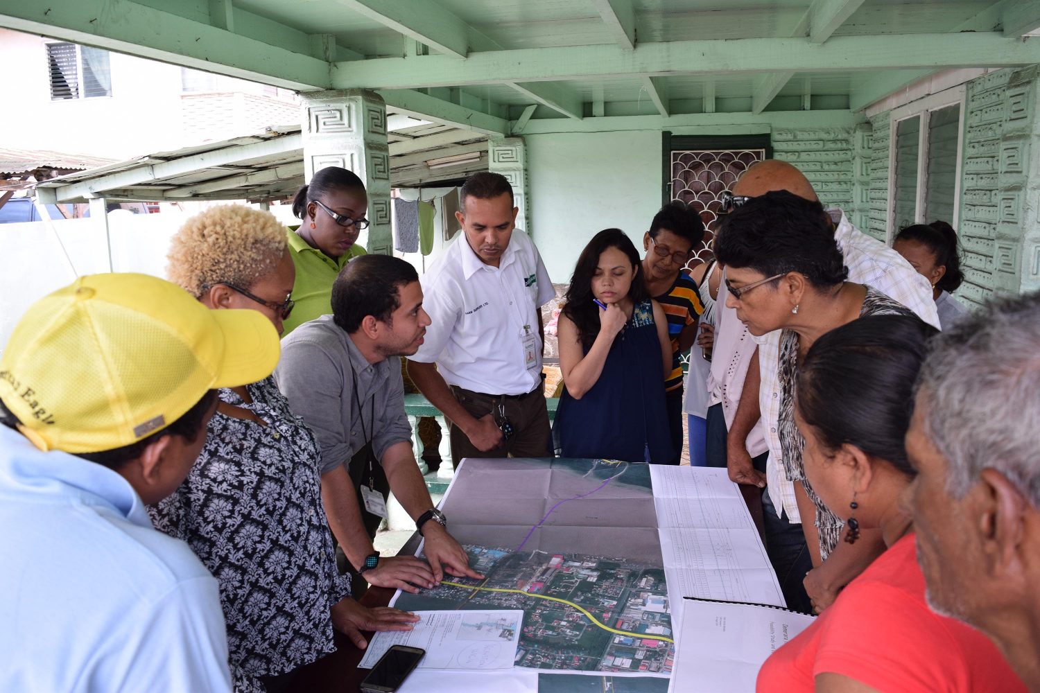 Senior Engineer, Ronald Roberts, of the Ministry of Public Infrastructure explains alignment details for the New Demerara River Bridge to residents of Houston, East Bank Demerara. (Ministry of Public Infrastructure photo)