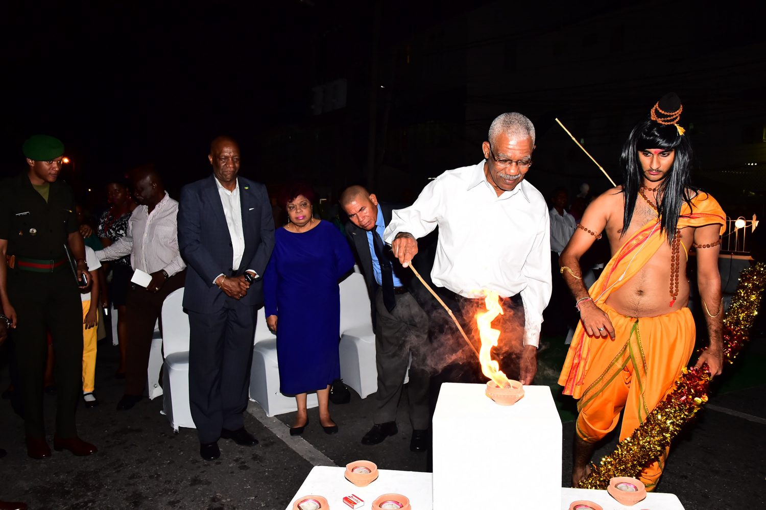 President David Granger lighting the ceremonial diya at the Ministry of Social Cohesion’s Diwali celebrations on Main Street last evening. (See story on centre pages.) (Ministry of the Presidency photo) 
