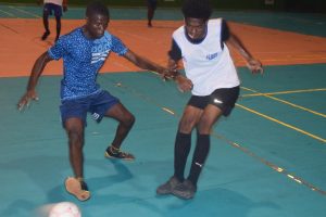 Eusi Phillips (left) of Sparta Boss tussling with Josiah Charles of Hustlers during their quarterfinal clash at the National Gymnasium, Mandela Avenue Saturday night.
