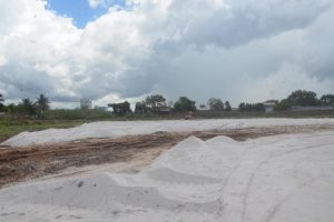 A section of the Providence Community Centre, the site for the inaugural FIFA Forward Project, is covered in white sand. The sub-base work is being conducted by subcontractor Nabi and Sons Limited.