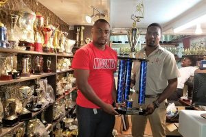Magnum Tonic Wine Brand Representative Edison Jefford (left) handing over the Championship trophy to LABA President Lawrence Simon for the Division-1 League at the Trophy Stall Bourda location
 