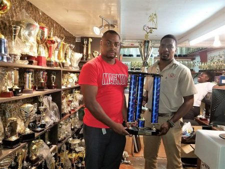 Magnum Tonic Wine Brand Representative Edison Jefford (left) handing over the Championship trophy to LABA President Lawrence Simon for the Division-1 League at the Trophy Stall Bourda location
 