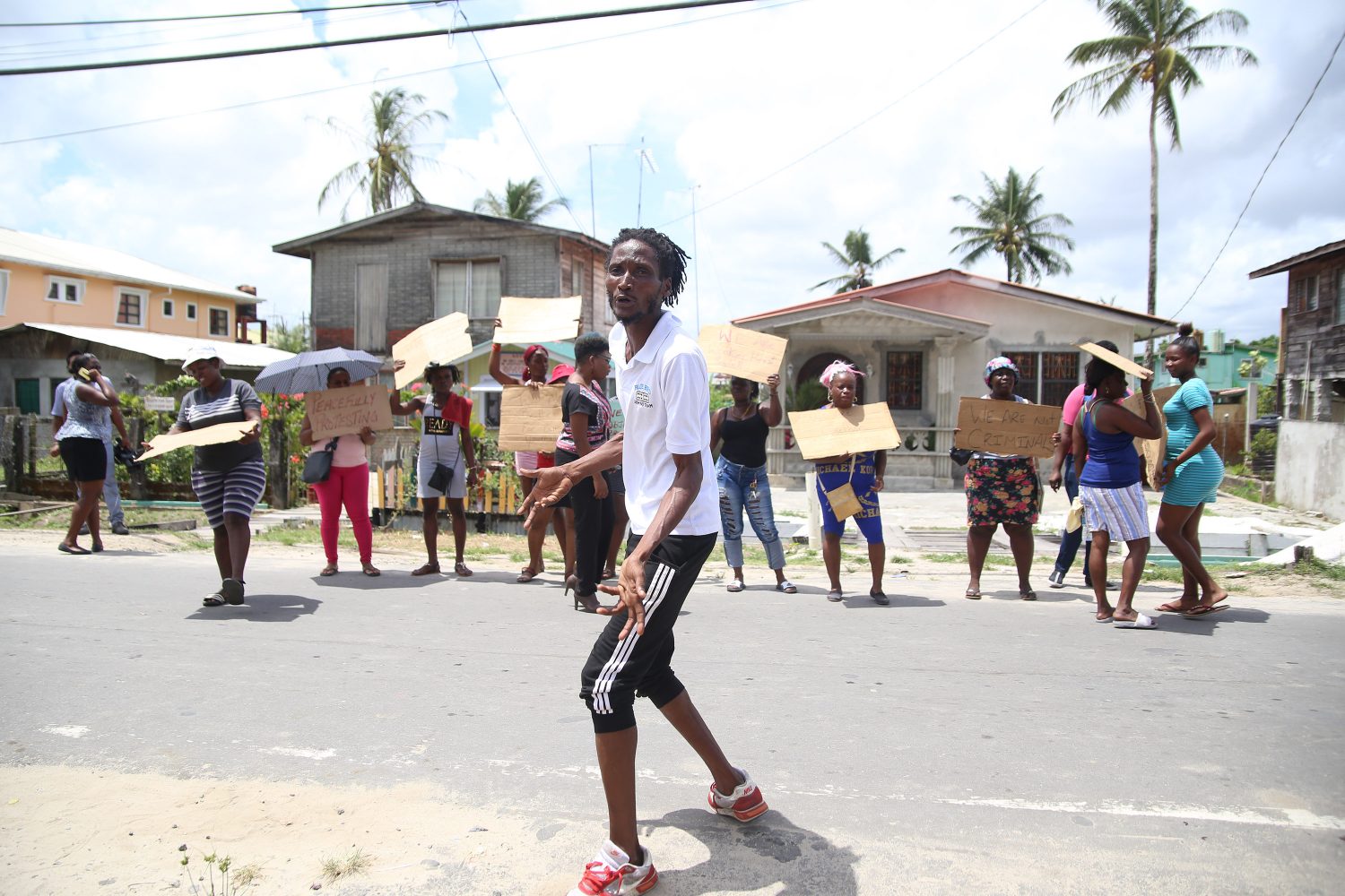 Phillip Chase directs his neighbours during the protest of the Mocha/Arcadia NDC. (Photo by Keno George)