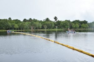 Participants learning how to deploy a containment boom used to contain oil during a spill (DPI photo)