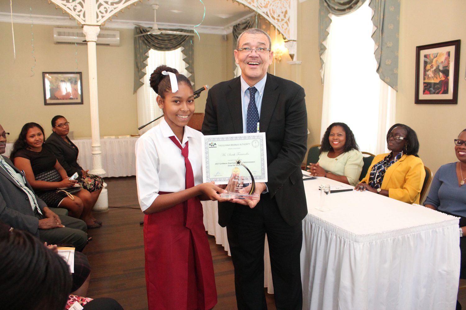 Sarah Fernandes receiving her prize from GRA Commissioner-General Godfrey Statia (GRA photo)