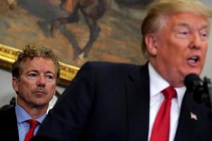 U.S. Senator Rand Paul (R-KY) listens as U.S. President Donald Trump speaks before signing an executive order making it easier for Americans to buy bare-bones health insurance plans and circumvent Obamacare rules at the White House in Washington, U.S., October 12, 2017. REUTERS/Kevin Lamarque