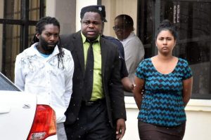 Remueako Jarvis, 32, left, and Sharmellia Garcia, 28, appeared before a Rio Claro magistrate yesterday charged with the murder of her husband Larry Garcia on September 27.