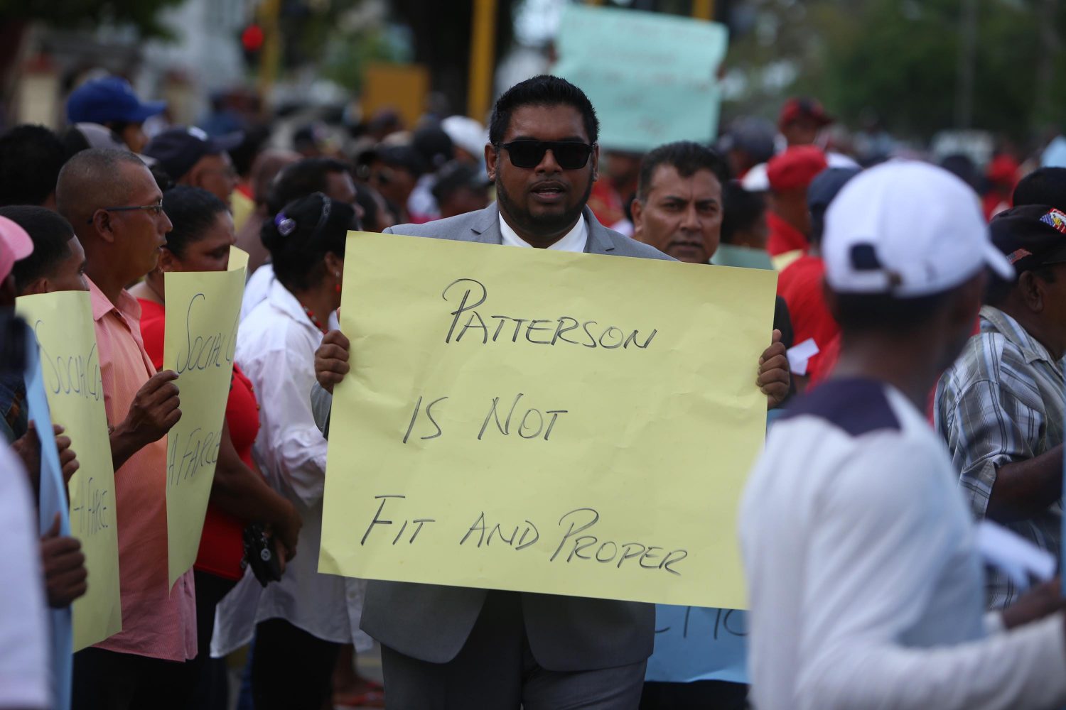 PPP/C Member of Parliament Irfaan Ali carried a placard, which reads “Patterson is not fit and proper” during the protest outside of the Public Buildings yesterday. 