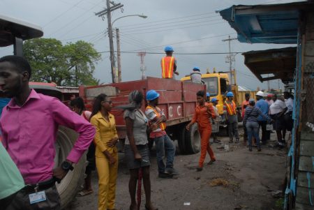 City Hall workers and vendors engaging prior to the start of the road repair works on Bourda street
