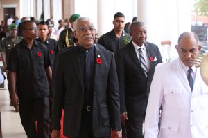 President David Granger (centre) being escorted to the Parliament Chambers yesterday.