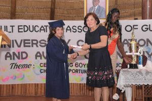 AEA celebrates 60th: First Lady, Sandra Granger (second from left) presents Mary Roberts with her Caribbean Certificate of Secondary Level Competence (CCSLC) certificate at the 60th Anniversary Graduation and Award Ceremony of the Adult Education Association (AEA) of Guyana on Saturday. Roberts is a student at the AEA centre in the Rupununi.  (Ministry of the Presidency photo)