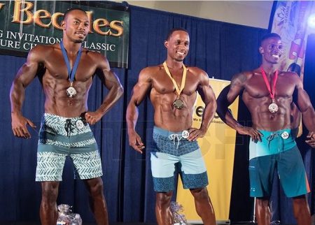 Guyana’s Emmerson Campbell, left, displays his silver medal.