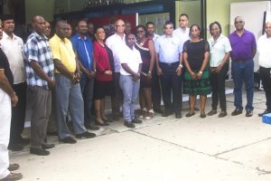 The employees who were recognised for 20 years of service pose with  Clifford Reis, Chairman/Managing Director (centre with glasses) and other officials. (Banks DIH photo)