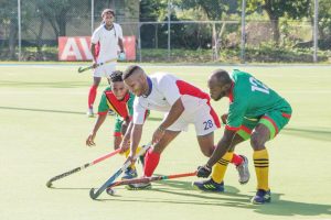 Hilton Chester (left) and Randy Hope (right) of Guyana, surrounds Puerto Rico’s Yaphet Melendez during their clash in the Central American and Caribbean Games 2018 Hockey Qualifiers, at the Mona Facility, Kingston, Jamaica, yesterday.