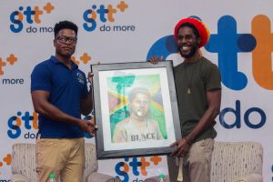 Artist Michael Griffith presents a portrait of the singer to him yesterday. (Terrence Thompson/Guyana Live photo)