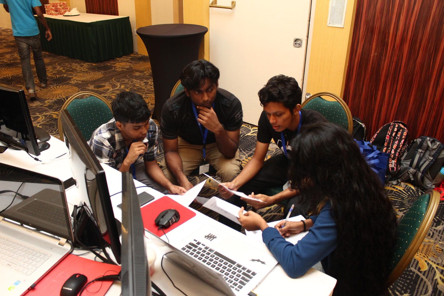 IntellectStorm team members discussing their plan before the competition began on Friday. 