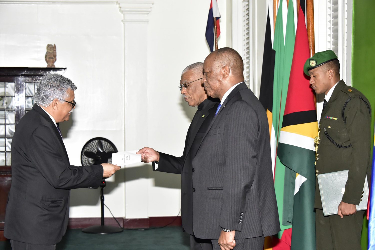 This Ministry of the Presidency photo shows Dr. Alfonso Munera Cavadia (left) presenting his letters of credence to President David Granger. At right is Minister of State Joseph Harmon.