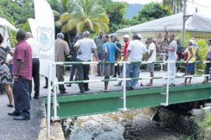 Residents stand on the new bridge at Covista Court off Spaniol Road, Covigne, Diego Martin, which was officially opened yesterday by Prime Minister Dr Keith Rowley and Rural Development and Local Government Minister Kazim Hosein.