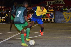 Devon Johnson (right) of Broad Street Bullies battling with a Howes Street player for possession of the ball during his team’s 3-0 victory at the Demerara Park in the Guinness ‘Greatest of the Streets’ Georgetown Zone