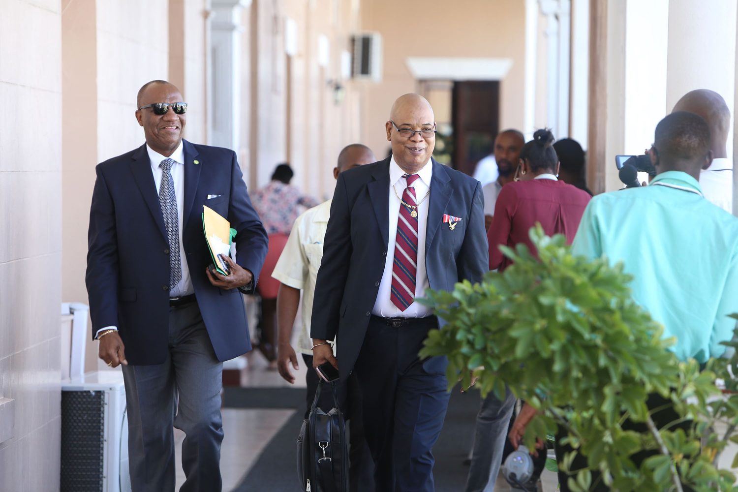 All smiles: Minister of State, Joseph Harmon (left) and PPP/C MP Juan Edghill on their way to Parliament Chambers for Monday’s presentation of the 2018 budget.