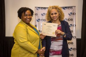 Country Representative of the IDB, Sophie Makonnen (right) handing out a certificate to one of the participants. (IDB photo)