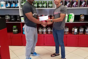 CEO of Fitness Express, Jamie McDonald presenting the show’s organizer, Videsh Sookram with a financial pacts to offset expenses for Saturday’s fixture which is scheduled to attract athletes from Barbados, Suriname, Guyana and Trinidad and Tobago.