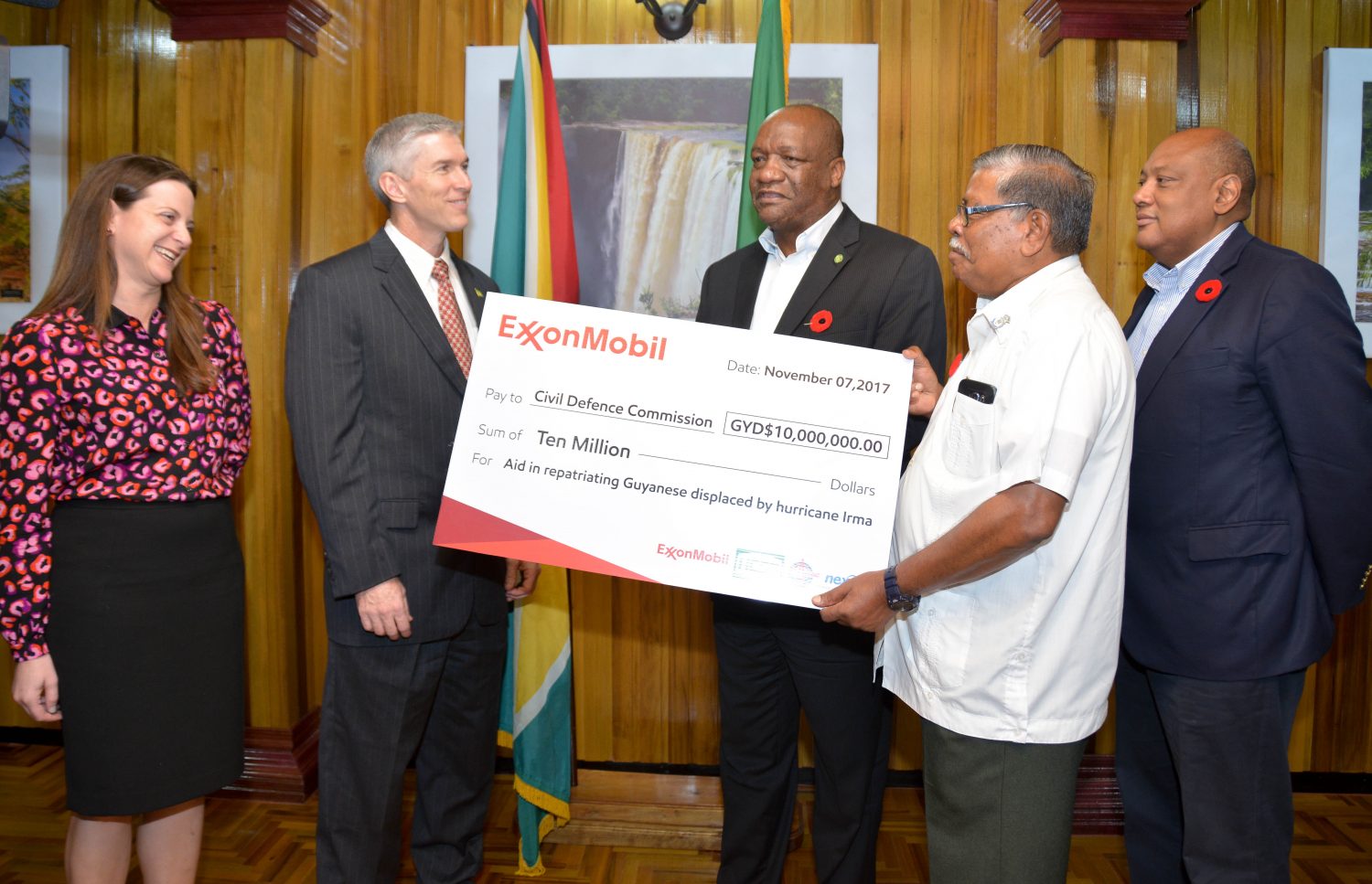 Rod Henson (second from left), ExxonMobil Guyana’s Country Manager after handing over the cheque to Minister of State, Joseph Harmon (centre) and Director General of the Civil Defence Commission, Colonel Chabilall Ramsarup (second from right) as Minister of Natural Resources,  Raphael Trotman (right).  (Ministry of the Presidency photo)

