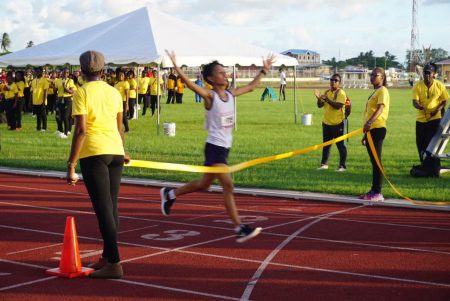 Rickie Williams victoriously crossing the finish line yesterday. 