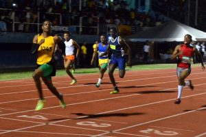 Best Ever! Daniel Williams glances at the clock before breaking the Boys u-18 100m record last evening at the National Track and Field Centre. (Orlando Charles photo)