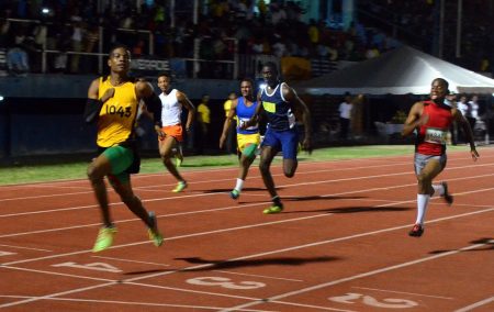 Best Ever! Daniel Williams glances at the clock before breaking the Boys u-18 100m record last evening at the National Track and Field Centre. (Orlando Charles photo)