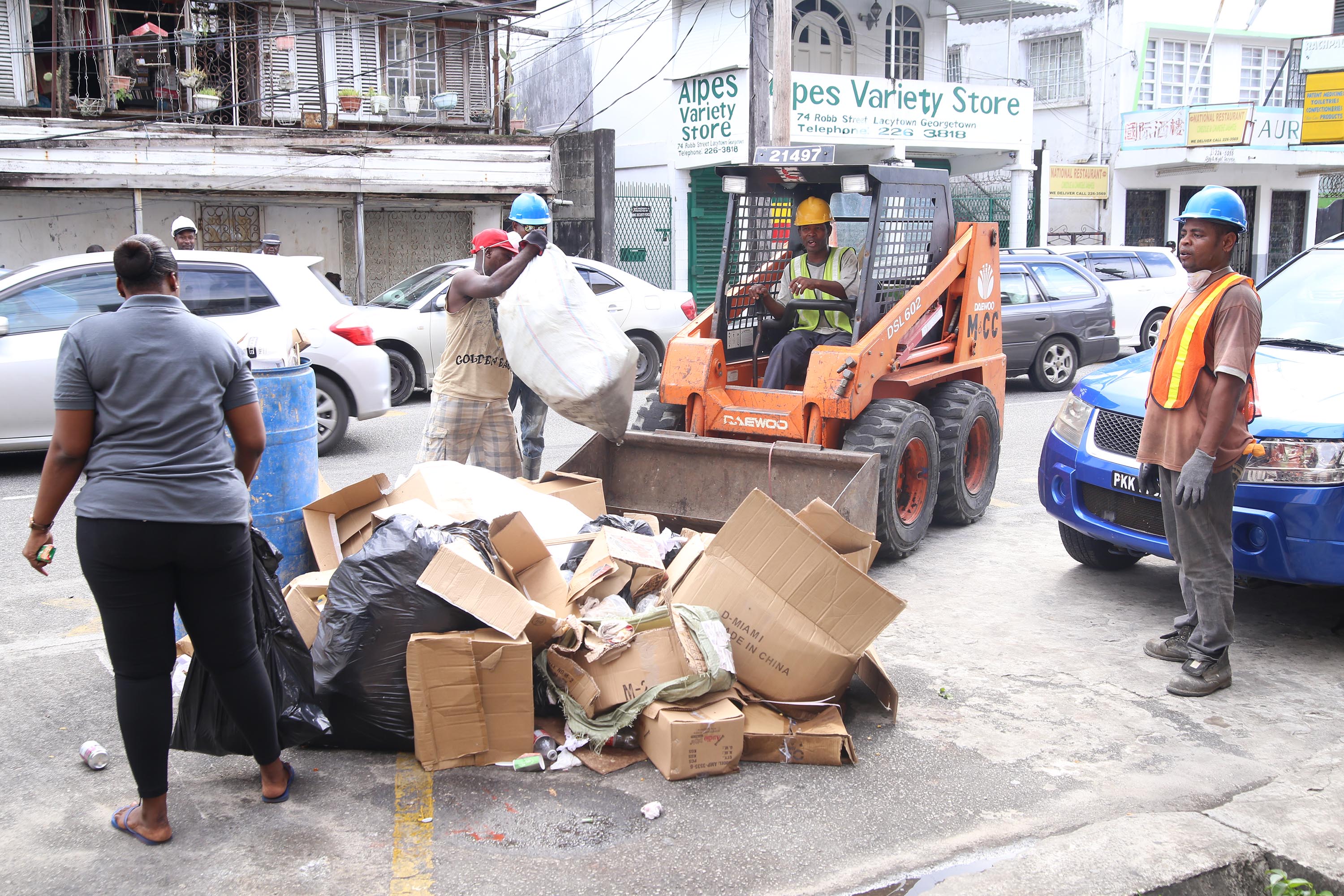 Workers from City Hall’s Solid Waste Department removing garbage