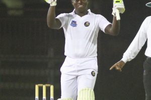 Guyana’s Anthony Bramble celebrates his maiden first class century off the Leeward Islands Hurricanes’ attack, last evening at the National Stadium, Providence (Orlando Charles photo)