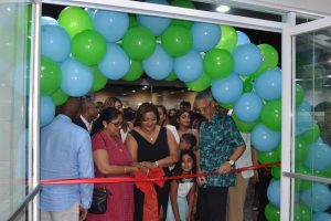 The wives of Prime Minister Moses Nagamootoo and Chairman of Beepat’s Group Roy Beepat, respectively, Sita Nagamootoo (second from left) and Monica Beepat (third from left) along with Minister of Business Dominic Gaskin (right) cutting the ceremonial ribbon declaring the FoodMaxx supermarket opened. The US$1M, 52,000 sq. ft., supermarket was declared opened on the ground floor in the Giftland Mall yesterday.  The supermarket which seeks to revolutionise grocery shopping in Guyana will open its doors to the public from 5pm today.  