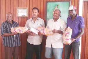 In this Stabroek News file photo Humphrey (second from right) and friends pose with bread from the bakery. 