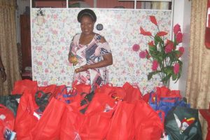 Hampers for the elderly: A member of the Grove Seventh-day Adventist Church welfare department with some of the hampers that were distributed to old persons at the Grove, Craig, Samatta Point, and Prospect Squatting area’s annual old folks’ party. The group catered to a total of 87 persons including shut-ins.
Image saved as Grove Distribution in pictures in file Oliceia Tinnie