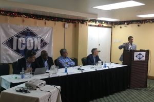 Seated from left: Icon’s Vice President Nelson Garcez, Icon Chairman, Stephen Scoon, DDL Chairman Komal Samaroo, Icon Chief Technical Officer, Hugo Armella, along with Icon President John Thompson (at the podium), during Icon’s official launch yesterday at Cara Lodge.