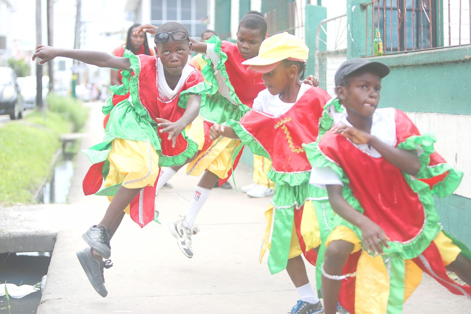 Many masquerade bands have once again taken to the streets for the Christmas season, keeping the tradition alive. In this Keno George photo, a troupe of young masqueraders show off their moves near the junction of Camp Street and North Road.