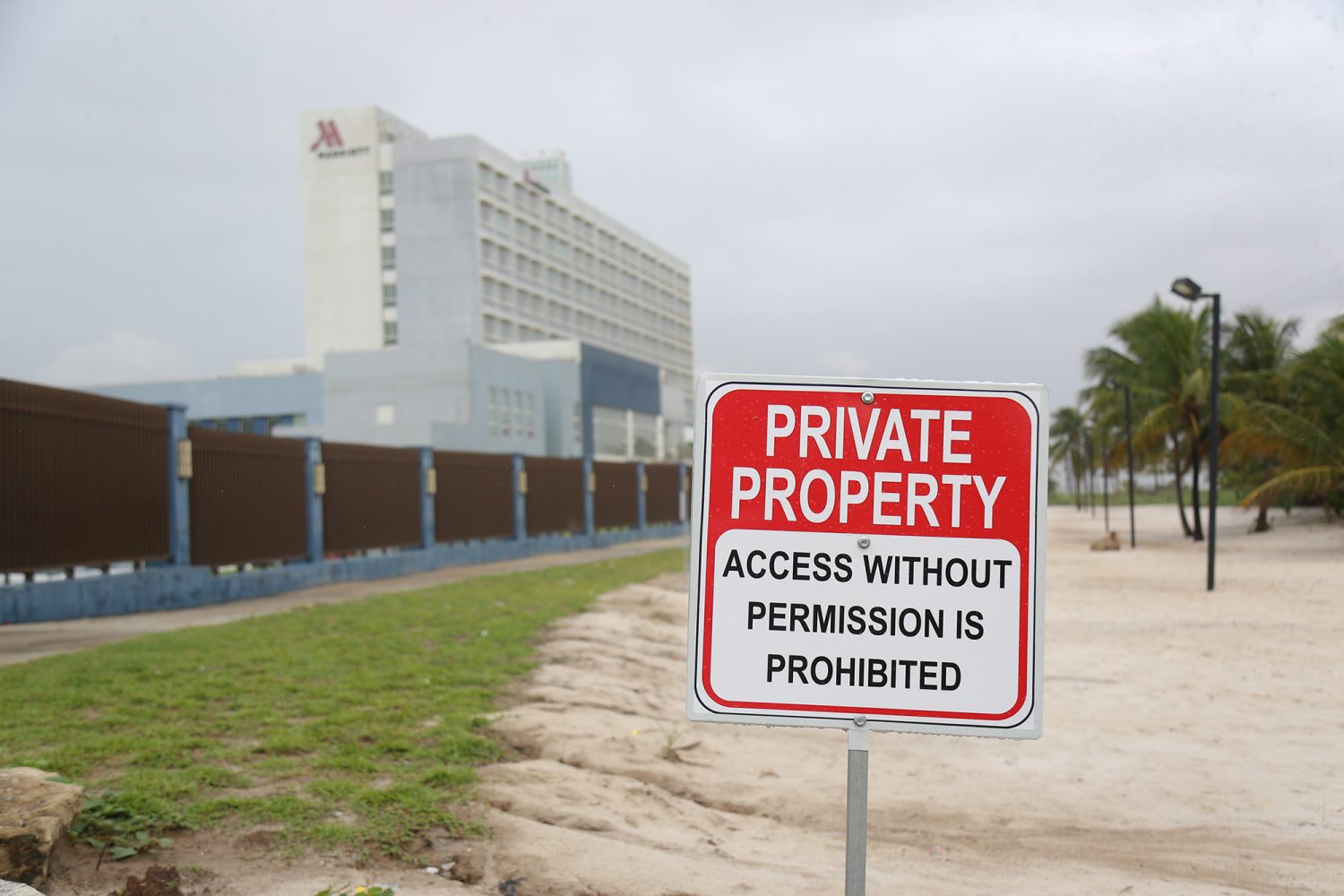 One of the nearly 20 signs erected by the Marriott Hotel describing the sandy area beyond its fence as private property. 