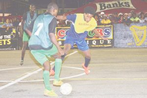 Devon Johnson (right) of Broad Street Bullies battled with a Howes Street player for possession of the ball during his team’s 3-0 victory at the Demerara Park in the Guinness ‘Greatest’ of Streets’ Georgetown Zone. (Photograph published on November 8th)