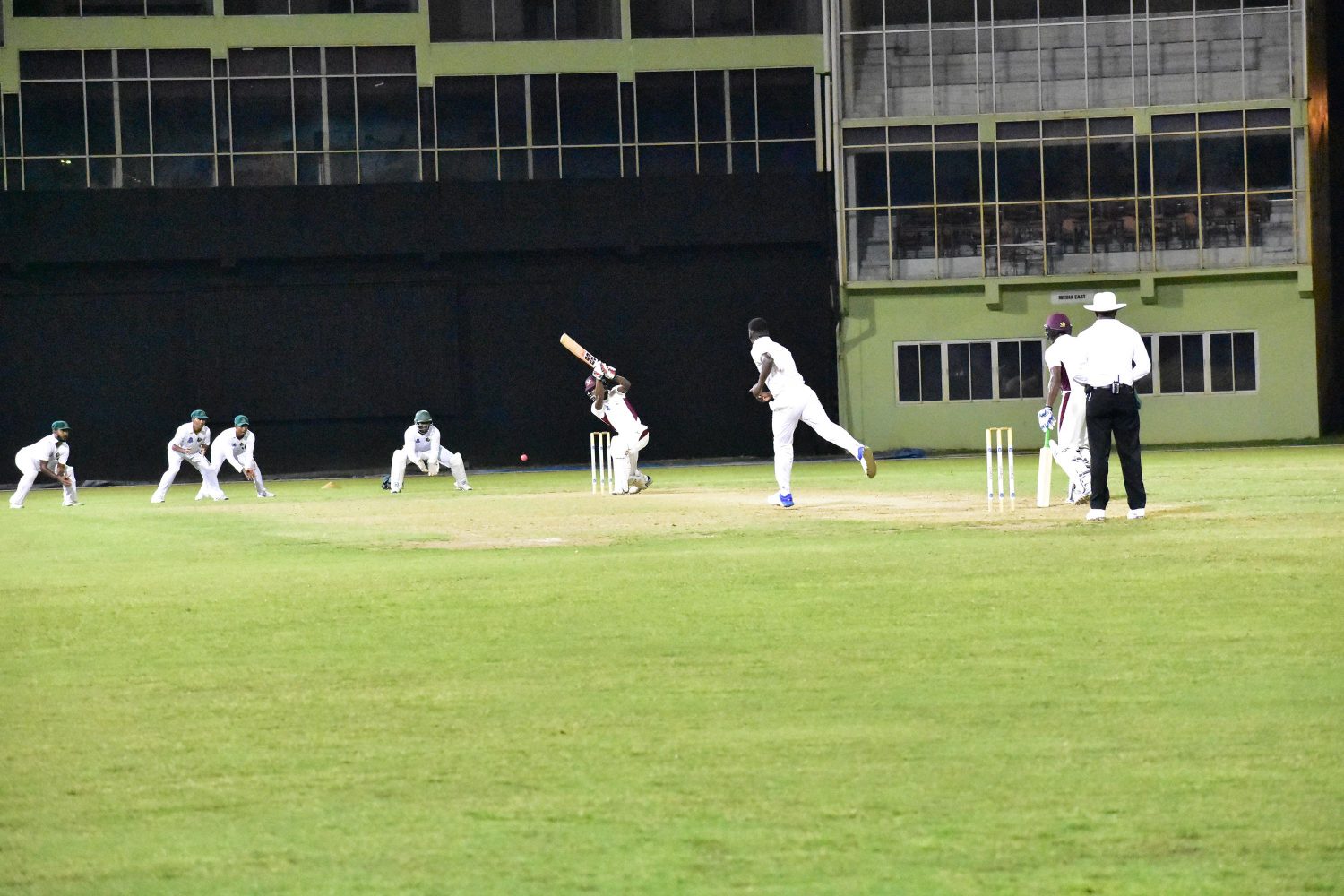 Night cricket at the stadium. Jaguar Sherfane Rutherford  bowls to Hurricanes’ Akeem Saunders whilst wicketkeeper Bramble and the Guyana slip cordon pay keen attention