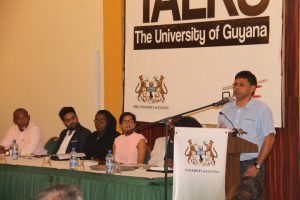 Nand Persaud (right) speaking at the UG forum (Department of Public Information photo)