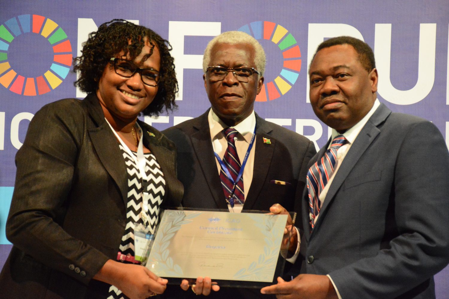Director General, Lt. Col. Egbert Field (centre) and  Minister Annette Ferguson (left), receiving the ICAO Council President’s Certificate from the ICAO Council President, Dr. Olumuyiwa Benard Aliu. 
