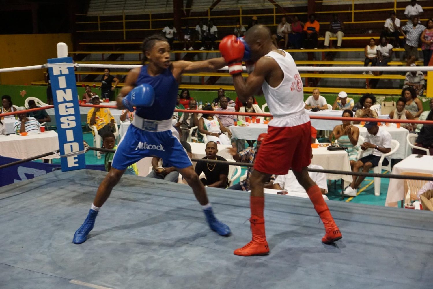 Keevin Allicock (left) of the Forgotten Youth Foundation (FYF) lands a crisp jab to the head of Clairmonte Gibson during their three-round fight which headlined the ‘Sons of Champions’ card on Boxing Day at the National Gymnasium.