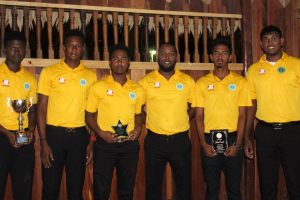 Coach Julian Moore (fourth from left) and his boys pose for a photo at the GCB’s annual award ceremony on Wednesday evening. Other in the photo are the five Guyanese selected for the West Indies under - 19 side. From left Ashmead Nedd, Ronaldo Ali Mohammed, Joshua Persaud, Raymond Perez and Bhaskar Yadram (Royston Alkins Photo) 